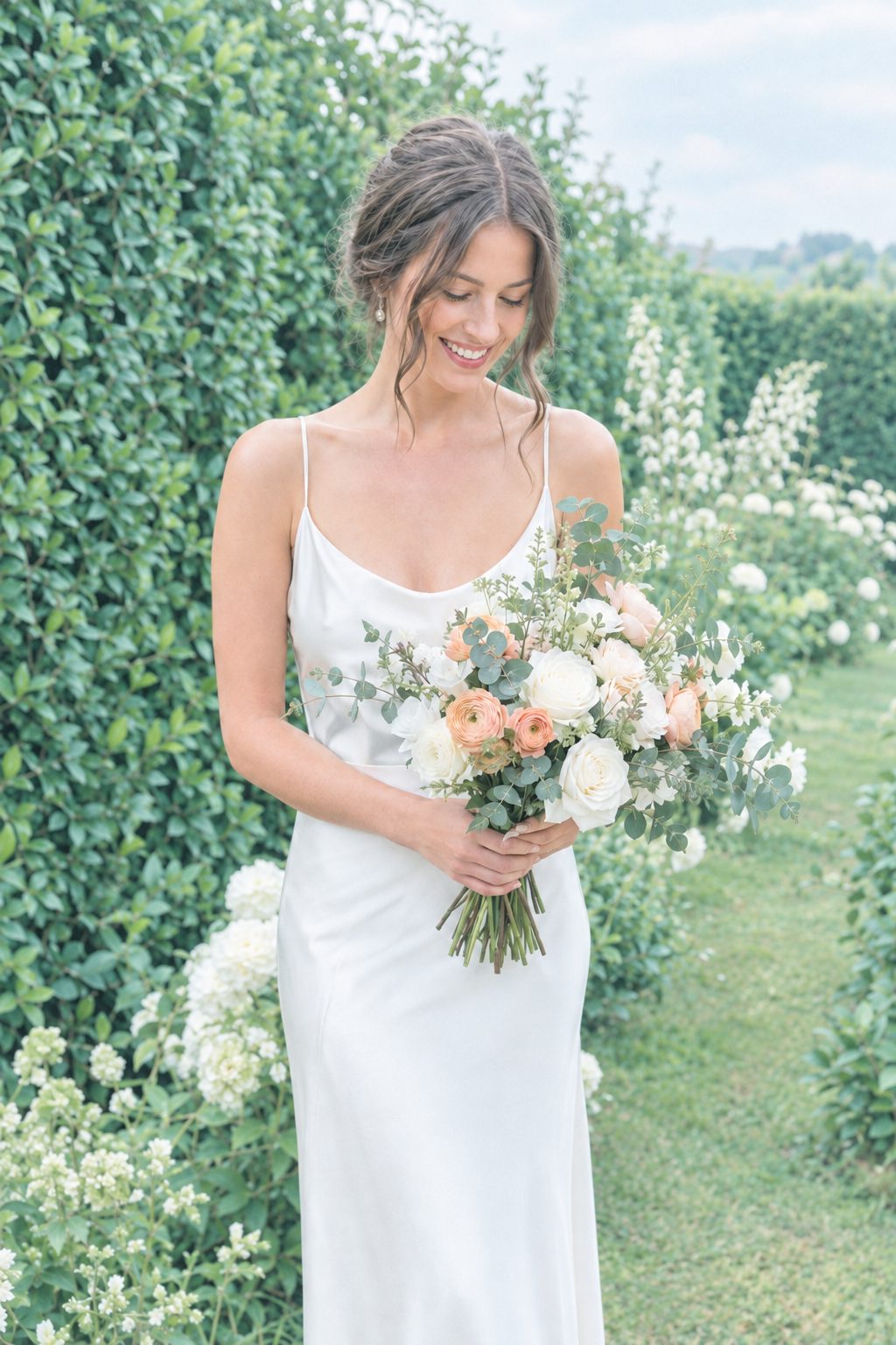 Bride with a bouquet of roses in a green garden in the Film 400 400 Signature look – after