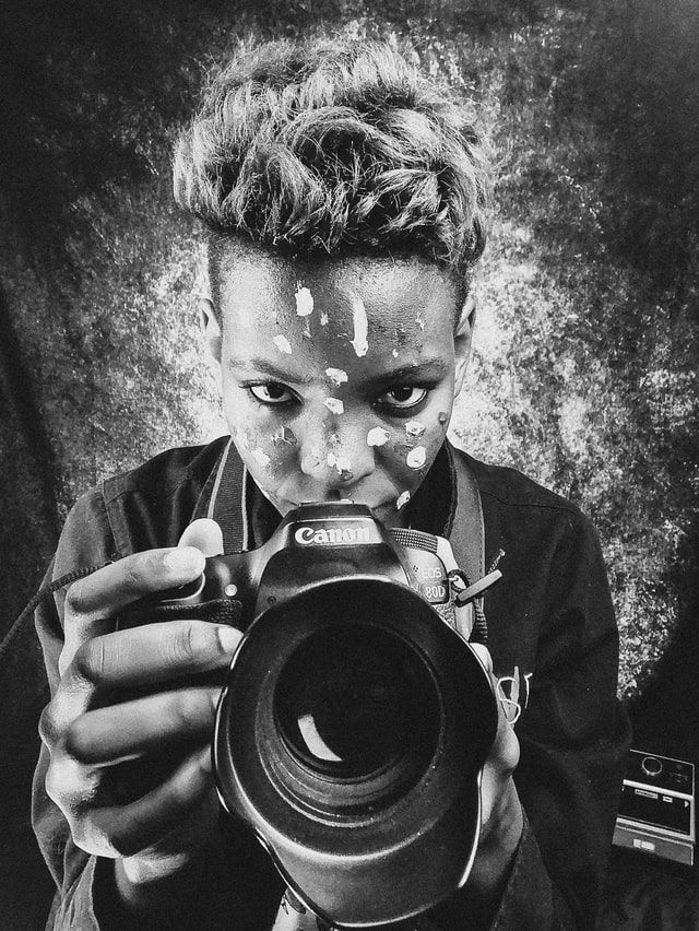 Photographer holding a camera in black and white