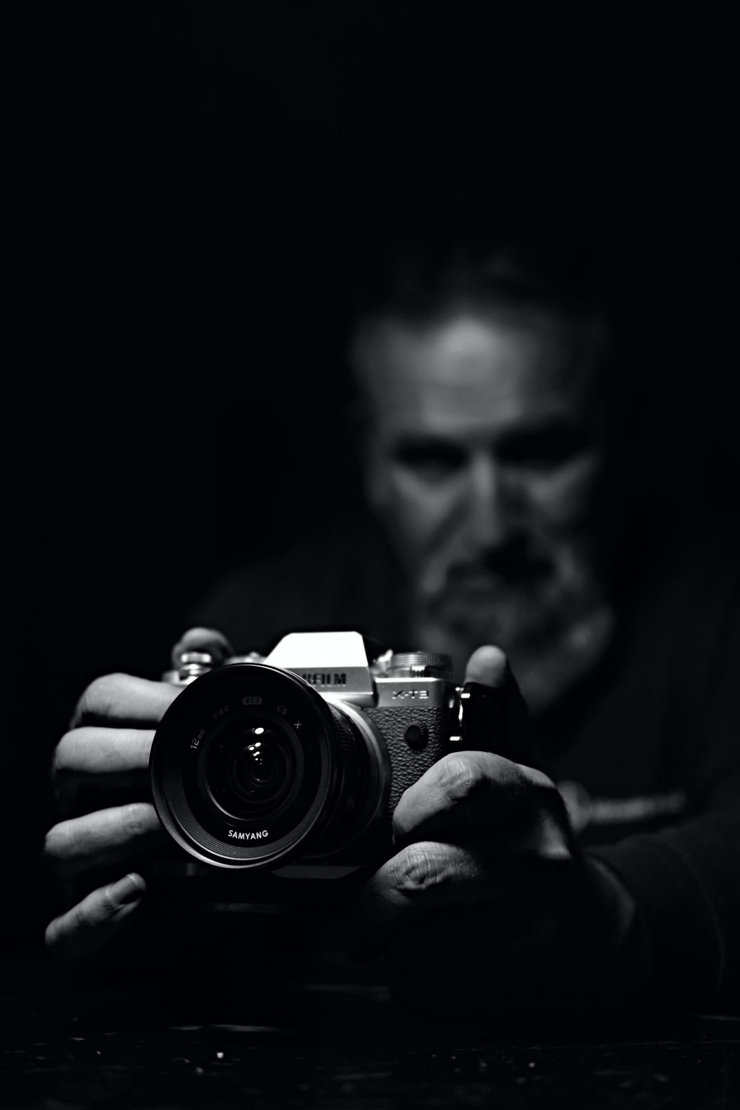 Photographer in the dark holding a camera